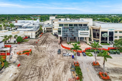 A building under construction with trees and a road

Description automatically generated